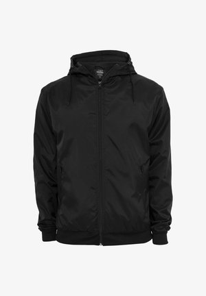 Schwarze Kapuzenjacke mit Frontreißverschluss und Kordelzügen, langen Ärmeln und seitlichen Reißverschlusstaschen, dargestellt vor weißem Hintergrund.