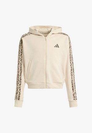 Sudadera beige con cremallera y capucha, con rayas de estampado de leopardo en las mangas, bolsillos delanteros y pequeño logo de Adidas en el pecho izquierdo.