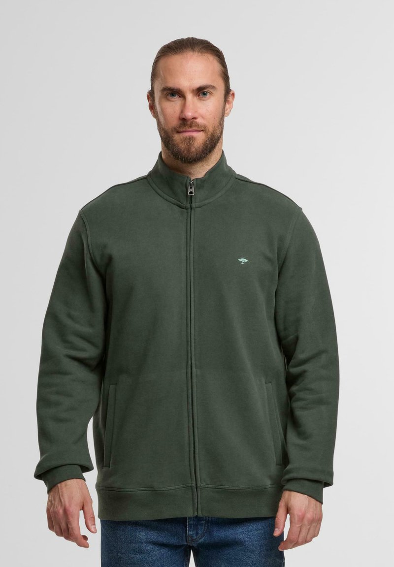 Grüner Reißverschluss-Sweatshirt mit hohem Kragen, Seitentaschen und kleinem Logo auf der Brust. Hergestellt aus weichem, strukturiertem Stoff.