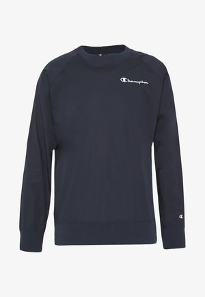 Felpa blu navy a maniche lunghe in misto cotone, con scollo rotondo, polsini a costine e logo "Champion" ricamato sul petto.