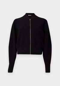 Svart ribbet zip-up cardigans med ståkrage, lange ermer og cropped design, med en sølvglinsende glidelås og tykk ribbet tekstur.
