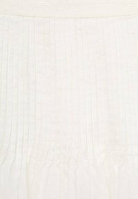 White skirt featuring vertical pleats and a gathered waistband. The texture appears soft, with a light, translucent quality.