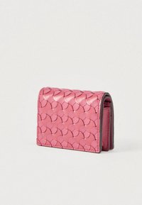 Compact pink leather wallet with a textured, scale-like pattern, shown partially open against a plain white background.
