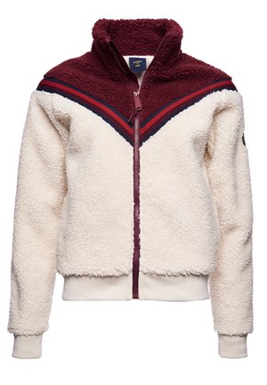 Fleece jacket with cream body, burgundy yoke, red and navy chevron stripes, full front zipper, and ribbed cuffs and hem.