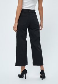 Desires DEFLORENCE PANTS - Bootcut-farkut - black