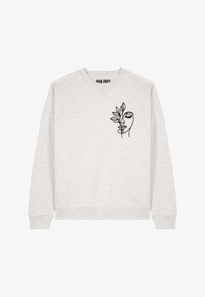 Sweat-shirt gris à manches raglan avec un dessin en contour noir représentant un visage et des feuilles sur le devant. Tissu doux et texturé.