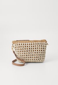 Woven straw bag in cream with a brown trim. Features a mesh design and a brown strap. Zipper closure at the top.