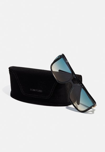 Occhiali da sole neri rettangolari con lenti blu sfumate, con dettagli in oro. Forniti con una custodia in velluto nero incisa con "TOM FORD".