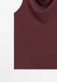 Sleeveless burgundy top with a cowl neckline, smooth fabric, and simple hem against a white background.