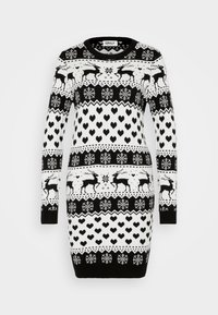 Robe en tricot présentant un motif festif noir et blanc avec des rennes, des cœurs et des flocons de neige. Manches longues et encolure ronde.
