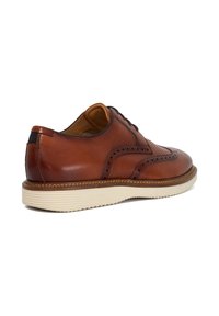Brown leather derby shoe with perforated detailing, contrasting white rubber sole, rounded toe, and stitched accents.