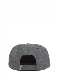 Gray wool cap with a rounded shape, snapback closure, and a tan button detail on top. Interior features a textured fabric lining.