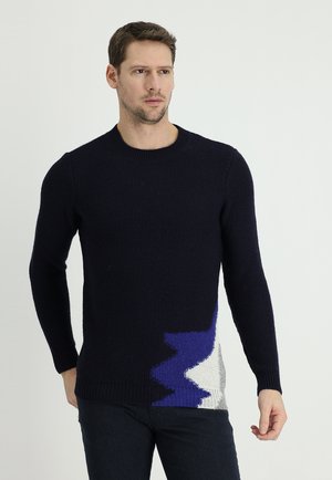 Navy knitted sweater with contrasting abstract patterns in blue and gray. Features a round neckline and long sleeves.