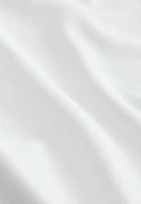 White fabric with a smooth texture, displaying subtle folds and slight sheen, indicating a lightweight, breathable material.