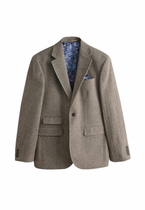 Veste en laine brun chevron avec revers cranté, deux poches avant à rabat, fermeture par un seul bouton, et doublure intérieure florale bleue assortie à la pochette.