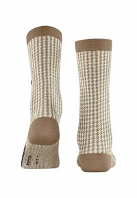 Patroon sokken in crèmekleurige en bruine tinten, met een geribbelde textuur, een houndstooth ontwerp, en effen bruine boorden en tenen.