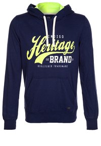 Navyblauer Kapuzenpullover mit Fronttasche, weißen Kordeln, neon-geliner Kapuzenfutter und dem Text "Heritage Brand" in Gelb und Weiß auf der Vorderseite.