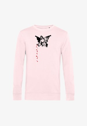 Roze long sleeve shirt met zwart engelenafbeelding op de borst, die een verticale stroom van kleine rode hartjes uit zijn hand laat vallen.