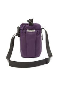 Purple fabric cylindrical bag with drawstring closure, front label "Cleptomanicx," and adjustable black shoulder strap.