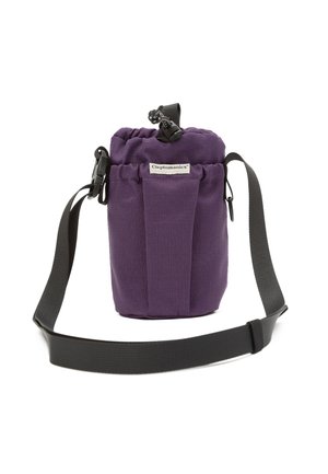 Purple fabric cylindrical bag with drawstring closure, front label "Cleptomanicx," and adjustable black shoulder strap.