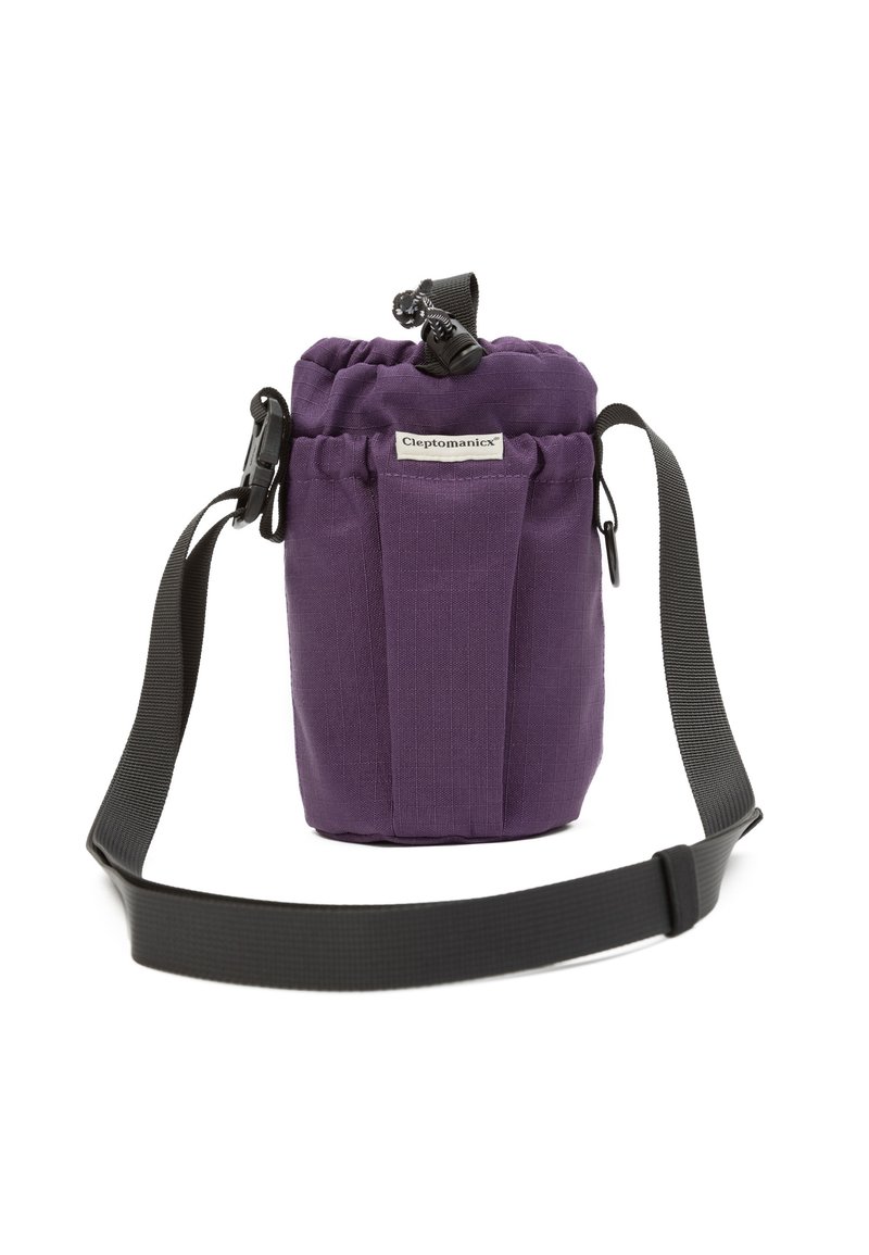 Purple fabric cylindrical bag with drawstring closure, front label "Cleptomanicx," and adjustable black shoulder strap.