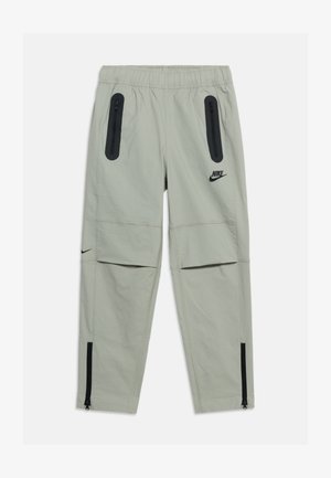Heledat hallid Nike püksid elastse vöökohaga, mustad tõmblukuga taskud reitel, põlveklapiga ja pahkluus tõmblukud. Mustad Nike logod reiel ja säärel.