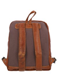 Ruskea kangasreppu, jossa on nahkaosat, pehmustetut olkahihnat, ylhäältä käyettävä kahva ja jämäkkä muoto. Huomionarvoista ompelua ja tyylikkäitä suunnitteluyksityiskohtia.