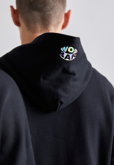 Black hoodie with a soft texture. Features a colorful, circular logo with the text "WOBAR" on the back of the hood. Simple design.