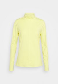 Långärmad polotröja i ljusgul tyg, med en figurnära design, mjuk textur och hög krage. Platta sömmar längs sidorna.