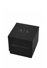 Black square box with a matte finish, featuring "A/X" logo and "ARMANI EXCHANGE" text in silver. Sharp edges, minimal design, no patterns.