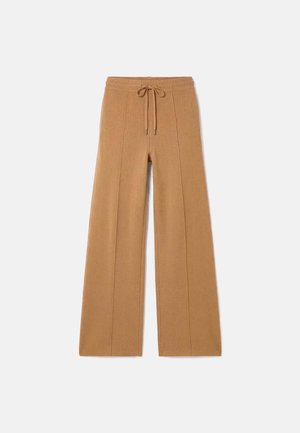 Pantaloni marroni a gamba larga con dettaglio cucitura frontale e vita elastica con coulisse annodata, distesi su uno sfondo bianco.