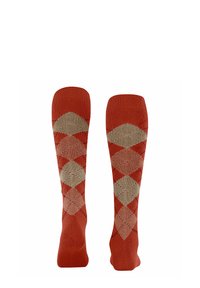 Calze alte fino al ginocchio di colore terracotta con un motivo a diamante in beige e marrone chiaro, con bordi a coste e texture liscia.