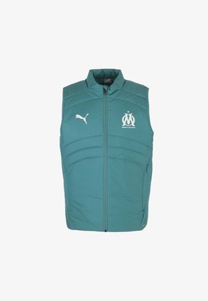 Gilet imbottito teal con colletto alto, zip frontale e logo Puma bianco insieme all'emblema del Marsiglia sul petto. Presenta pannelli cuciti.