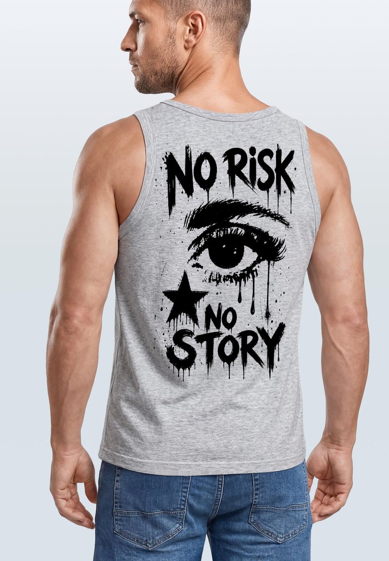 Man wearing grey sleeveless shirt with black graphic of an eye, a star, and the text "NO RISK NO STORY" on the back.