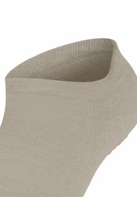 Calzino alla caviglia beige chiaro con una trama a maglia senza cuciture e apertura curvata.