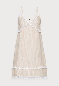 Vaaleanvärinen, kuvioitu mekko, jossa on ohuet olkaimet ja pom-pom-yksityiskohtia kaula-aukossa ja helmassa, valmistettu pehmeästä kankaasta.