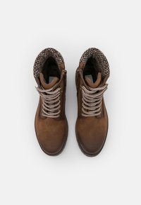 Brown leather boots featuring woven, knitted cuffs and thick, contrasting laces. Includes side zippers for easy wear.