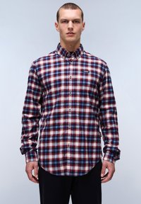 Langarm geruite overhemd in rood, marineblauw en wit. Kraag met knopen, gebogen zoom en borstlogo. Stof lijkt textuur te hebben.