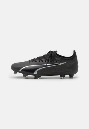 Black football shoes with textured synthetic upper, raised PUMA logo, lace-up design, and molded studs for traction.
