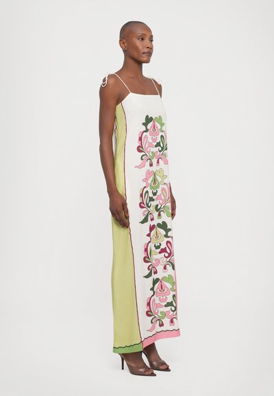 Long, sleeveless dress in pale green and white with floral pink and green patterns. Features shoulder ties and a straight silhouette.