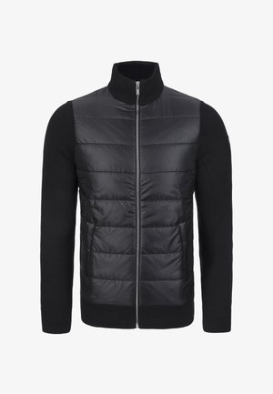 Zwarte hybride jas met een gewatteerde voorkant en gebreide mouwen. Heeft een hoge kraag en een ritssluiting van volledige lengte. Soepele, glanzende textuur aan de voorkant.