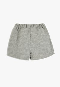 Pantaloni corti grigi realizzati in un tessuto testurizzato con una vita elastica e un taglio ampio, caratterizzati da un design semplice e pulito.