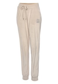 Beige joggings in een zachte stof met een elastische tailleband, trekkoord en zijzakken. Heeft de tekst "FEEL GOOD" in zilver afgedrukt op de heup.