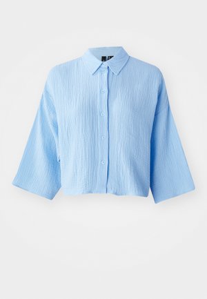 Light blue, textured cropped shirt with a button-down front, collar, and wide sleeves. Features six matching buttons down the front.