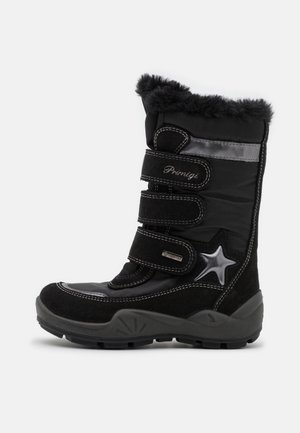 Bottes de neige noires avec une tige en textile et un tour en fausse fourrure, trois bandes velcro et un accent étoile sur le côté. Semelle en caoutchouc pour une meilleure adhérence.
