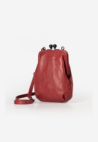 Red leather crossbody bag with a rounded shape, smooth texture, and top metal clasp. Includes an adjustable strap for convenience.