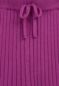Purple knitted fabric with vertical ribbing texture, featuring a drawstring tie at the waist for adjustable fit.