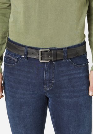 Black leather belt with a textured finish, featuring a silver metal buckle, worn over blue jeans and a green long-sleeve shirt.