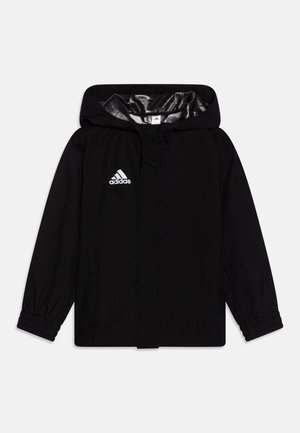Črna vetrovka s kapuco, elastičnimi manšetami in srebrno notranjostjo. Ponuja bel Adidas logotip na prsih in stranske žepe.
