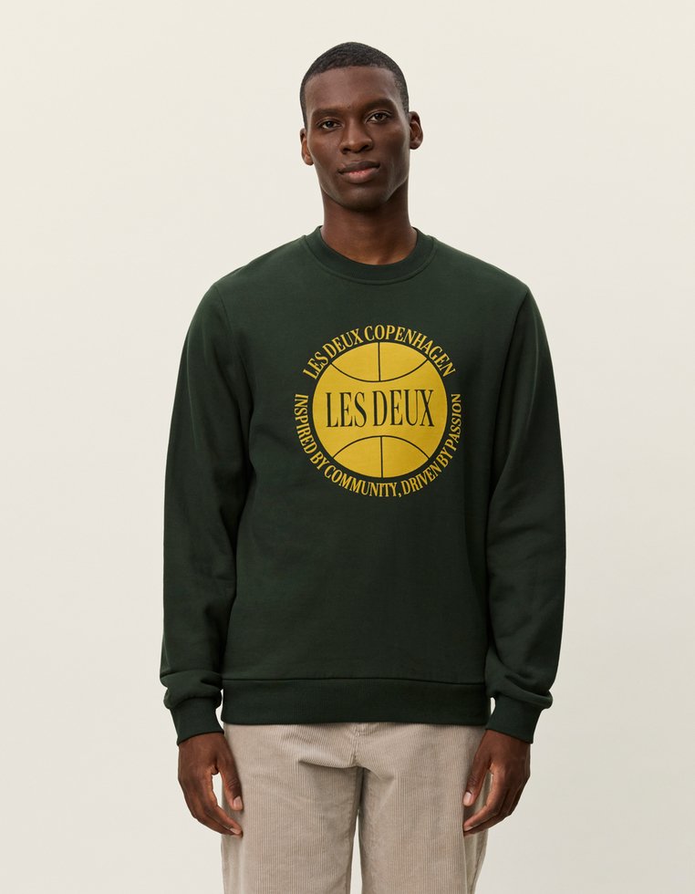 Σκούρο πράσινο φούτερ με στρογγυλή κίτρινη εκτύπωση που περιλαμβάνει το κείμενο "LES DEUX COPENHAGEN" και σχέδιο μπάσκετ, από βαμβακερό υλικό, με ribbed μανσέτες.